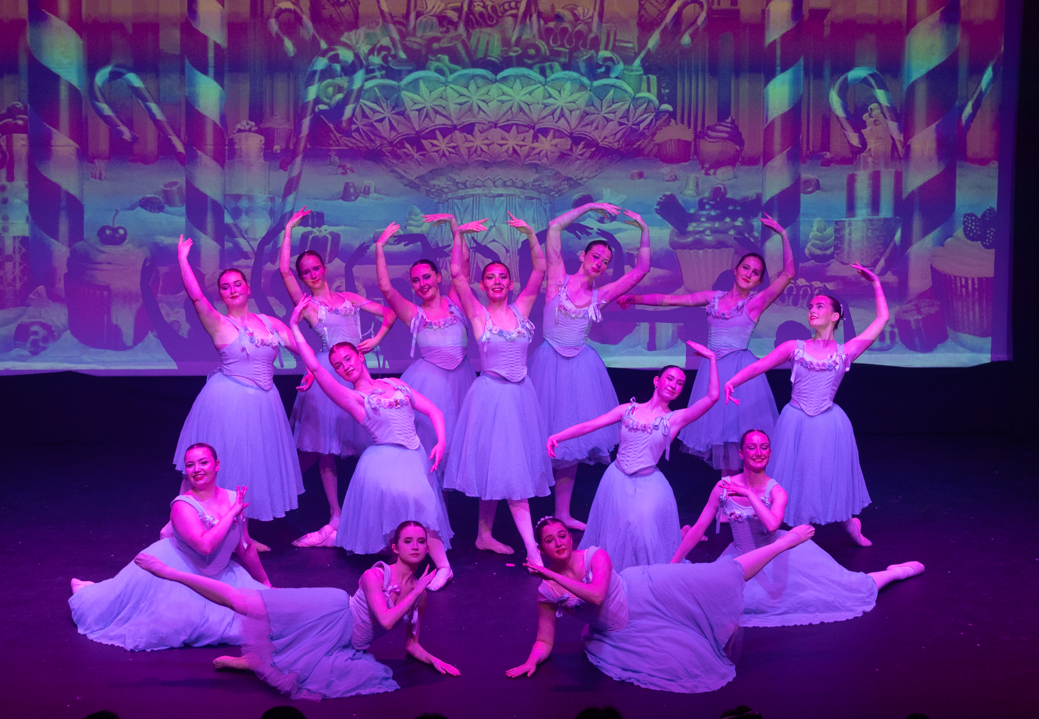 KAD dancers on stage under purple lighting KAD dancers on stage under purple lighting