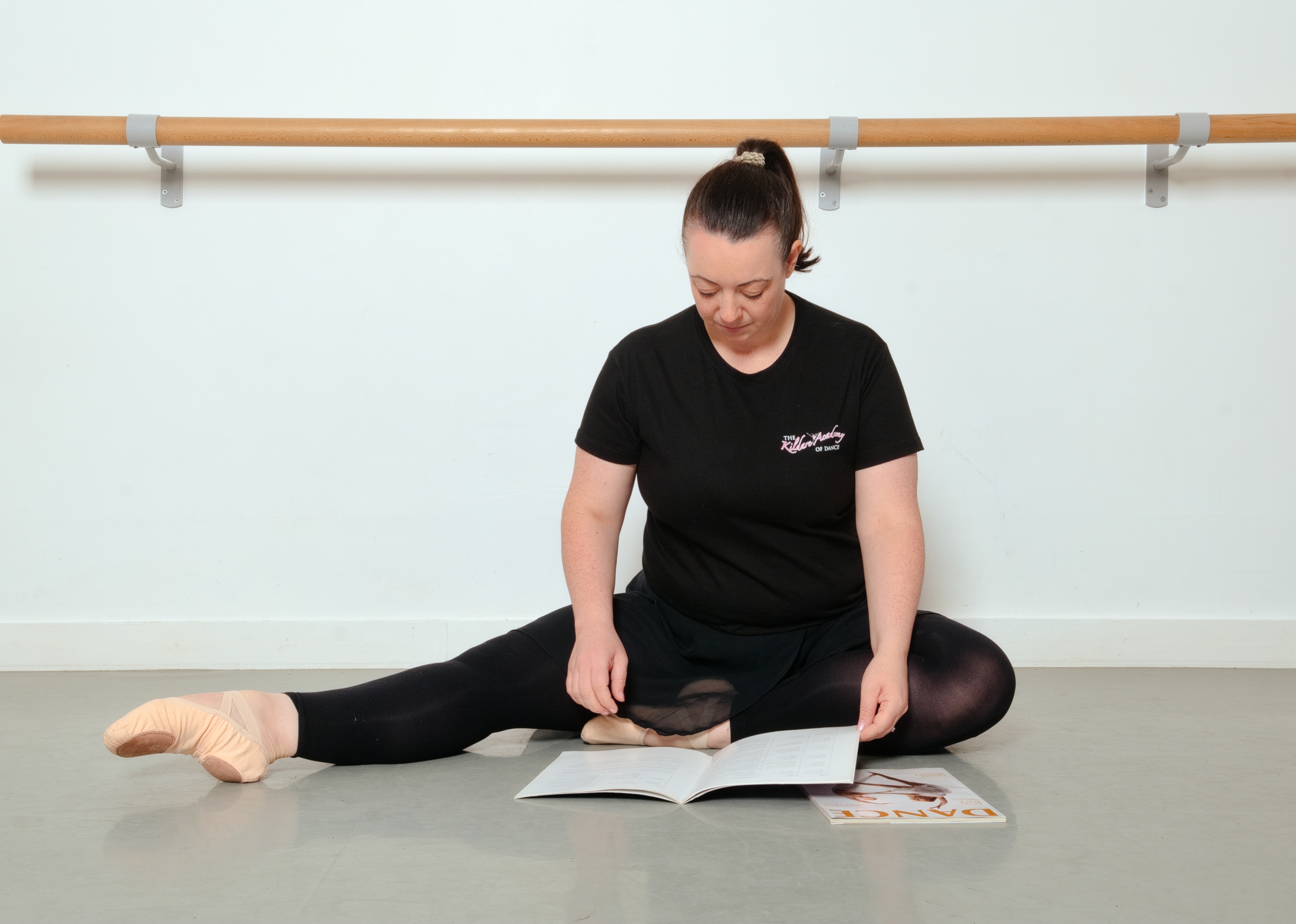 Dance tutor studying course material in the studio
